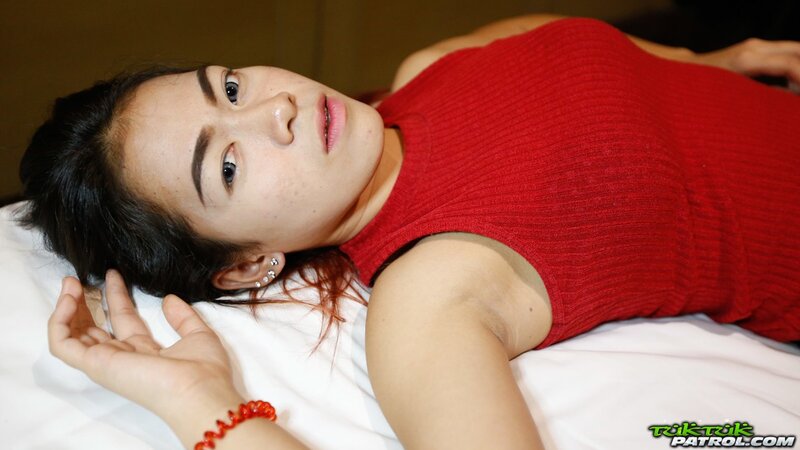 Thai babe with big expressive eyes shows off her tiny boobs and hairy pussy