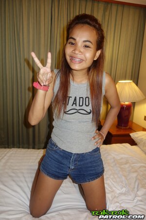 Teen Asian girl looks very cute despite the fact that she wears braces