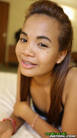 Teen Asian girl looks very cute despite the fact that she wears braces