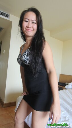 Good-looking Asian female carefully gets naked and touches her shaved pussy
