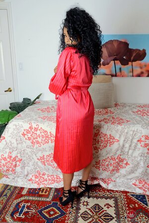 Black love with wonderful fuzzy hair opens her red robe showing off sweet charms