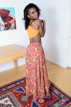 Playful Ebony girl with tiny titties shoves her sex hole spreading labia