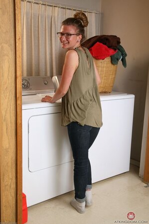 Small-tittied housewife with glasses climbs on washing machine to show hairy twat