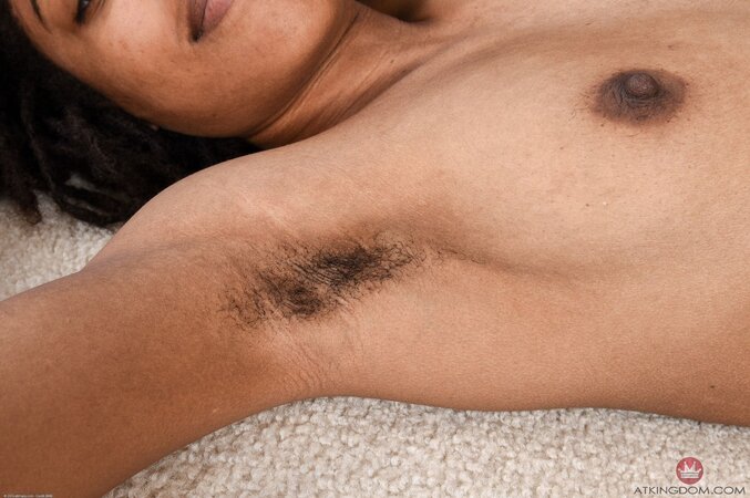 Young black woman with sexy full lips gets naked showing off her woolly vagina