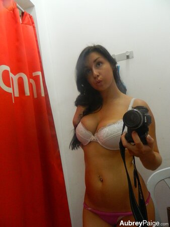 Young shopaholic acts very naughty in a fitting room located in the mall