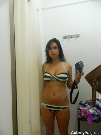 Young shopaholic acts very naughty in a fitting room located in the mall