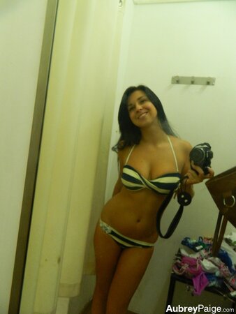 Young shopaholic acts very naughty in a fitting room located in the mall