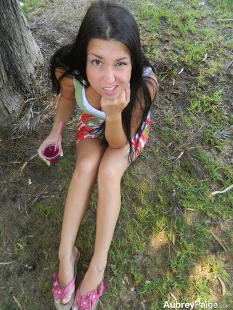 Brunette teen Aubrey Paige drinks juice and exposes her titties by the dishwasher
