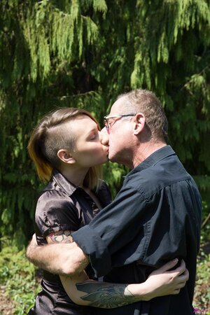 Girl with pierced nipple and tattooed back gives sexual pleasure to an old man