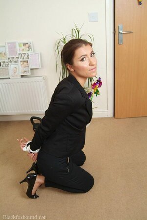 Office babe in high heels in a strict tuxedo suddenly gets tied up on the floor