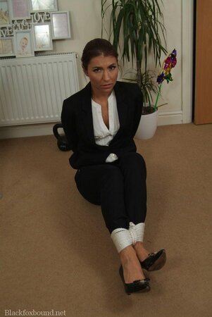 Office babe in high heels in a strict tuxedo suddenly gets tied up on the floor