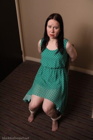 Pervert catches woman in green polka dot dress and ties her to chair