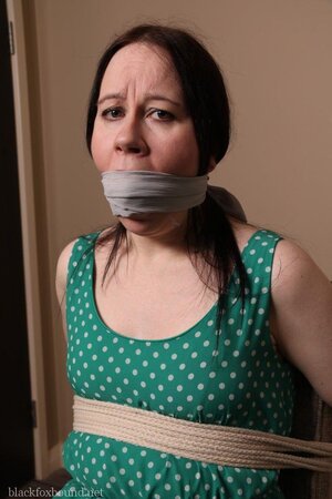 Pervert catches woman in green polka dot dress and ties her to chair