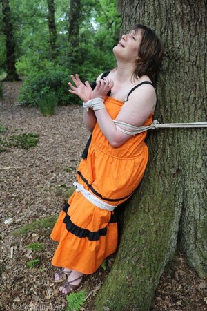 Helpless housewife is captured by lover and tied up to tree in public park