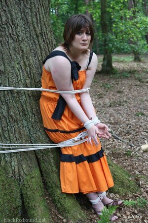 Helpless housewife is captured by lover and tied up to tree in public park