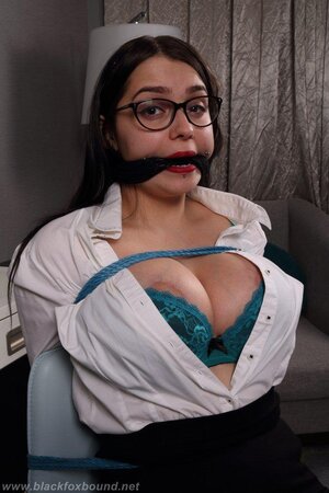 Tied up girl can't hide her huge hooters under the tight white shirt
