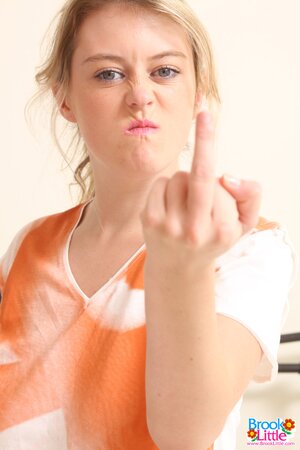 Pornstar from Great Britain gives the middle finger and exposes her boobs