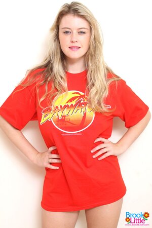 Girl takes her red T-shirt and black shorts off but leaves shoes and panties on