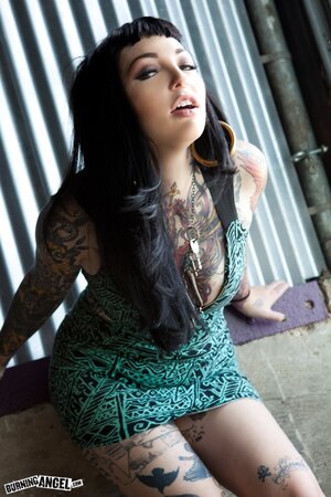 Tattooed brunette with hoop earrings shows how her smooth pussy looks like