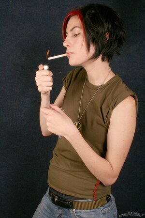 Winning beauty smokes cigarette before undressing to pose fully naked