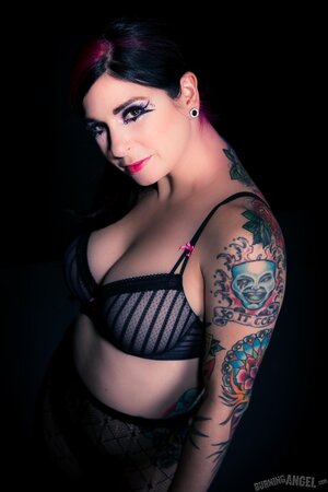 Busty brunette illuminates a dark room with her naked tits and tushy