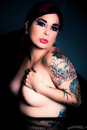 Busty brunette illuminates a dark room with her naked tits and tushy