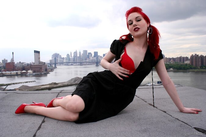 Tempting teen with red hair and high heels takes her black dress off on a roof