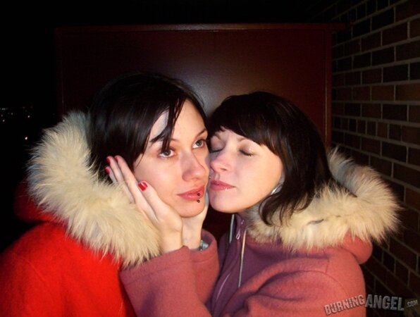 Lovely girls drink beer outdoors and this makes them eager to touch each other