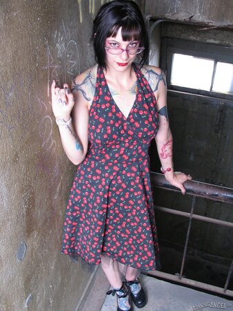 Female with glasses and piercing in clitoris demonstrates her naked body