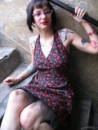 Female with glasses and piercing in clitoris demonstrates her naked body