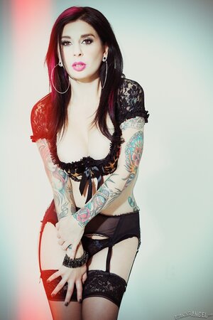 Tattooed MILF with great body takes off lingerie and poses only in stockings