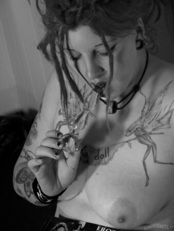 Chick with fuzzy hair reads a magazine and masturbates in black and white