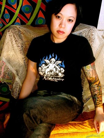 Oriental teen flashes her tattoos all over the petite body in close-up