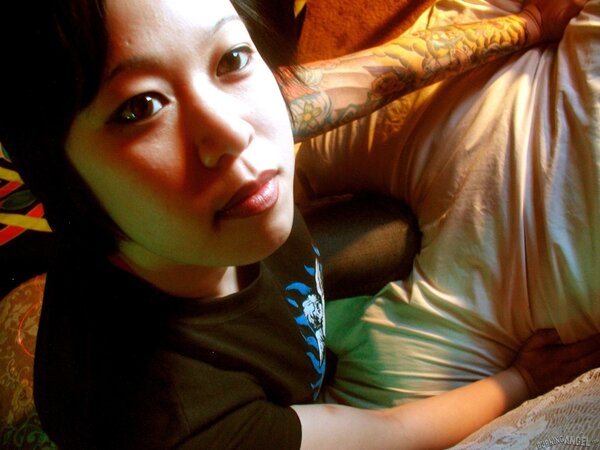 Oriental teen flashes her tattoos all over the petite body in close-up