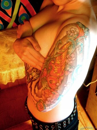 Oriental teen flashes her tattoos all over the petite body in close-up