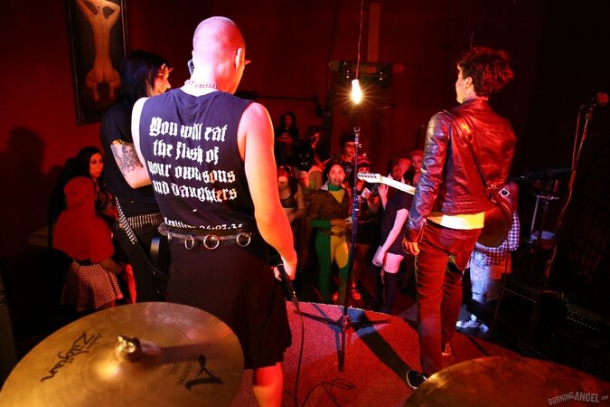 Girl is living it up at a rock concert and as singer comes closer she kisses him