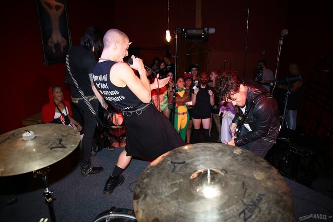 Girl is living it up at a rock concert and as singer comes closer she kisses him