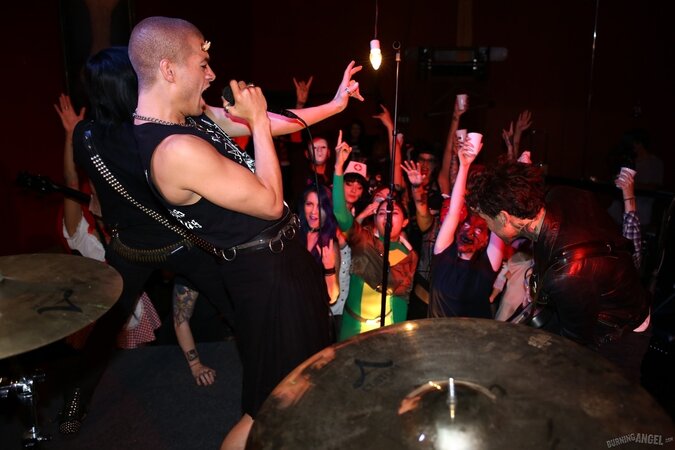 Girl is living it up at a rock concert and as singer comes closer she kisses him