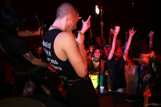 Girl is living it up at a rock concert and as singer comes closer she kisses him