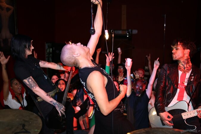 Girl is living it up at a rock concert and as singer comes closer she kisses him