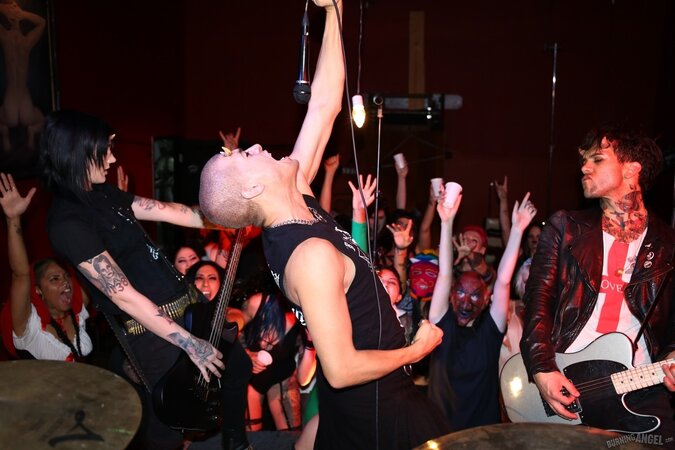 Girl is living it up at a rock concert and as singer comes closer she kisses him