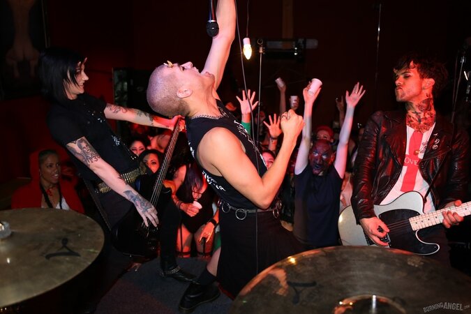 Girl is living it up at a rock concert and as singer comes closer she kisses him