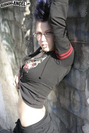 Sexy goth girl with glasses and mohawk shamelessly exposes her pussy outdoors