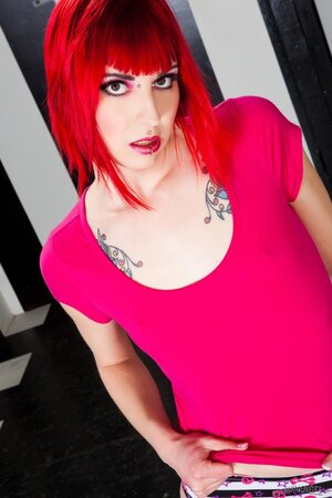 Small-tittied redhead with a septum and low lip piercing exposes pink cunt