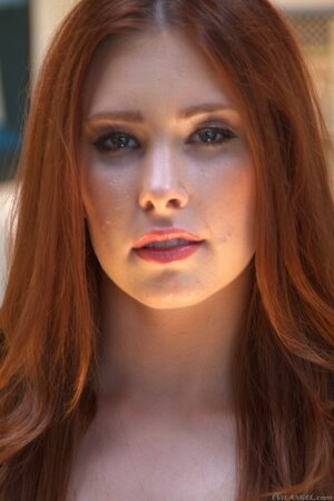 Temptress with red hair knows how to dress up to make guys horny as hell