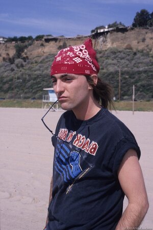 Guy in red bandana plays guitar pretty well but girls are interested in threesome