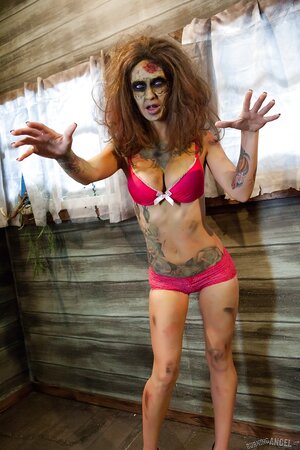 Female zombie with blue eyes and tattoos looks for a cock to satiate pussy