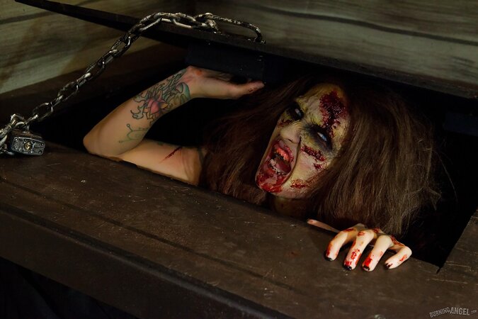 Female zombie with blue eyes and tattoos looks for a cock to satiate pussy