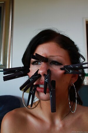 Woman demonstrates clothespins all over her face and a tail in her tushy