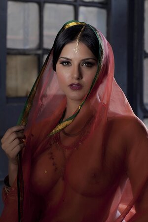 Diva in a transparent red sari fails to hide her big melons with dark nipples